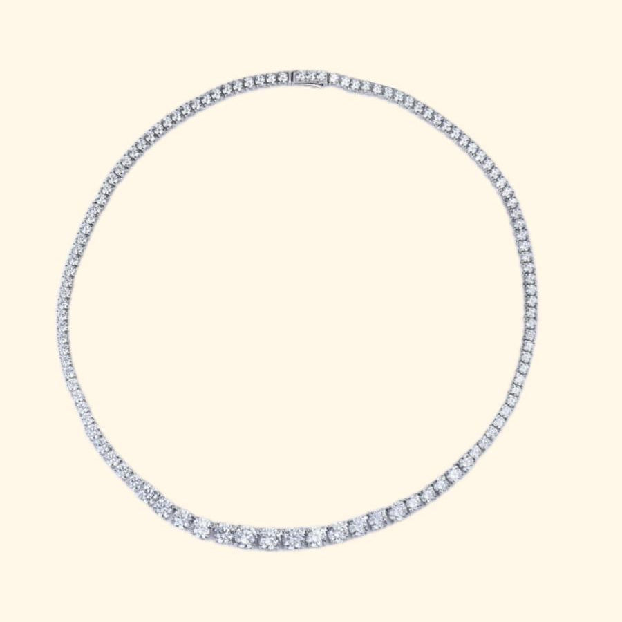 Silver hoop earring with blue gemstones on a beige background