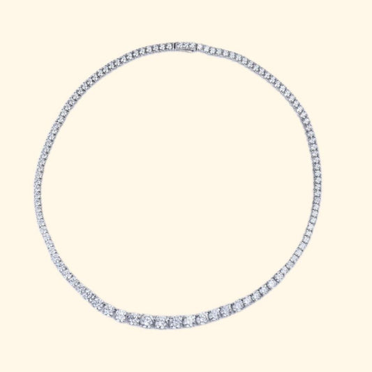 Silver hoop earring with blue gemstones on a beige background