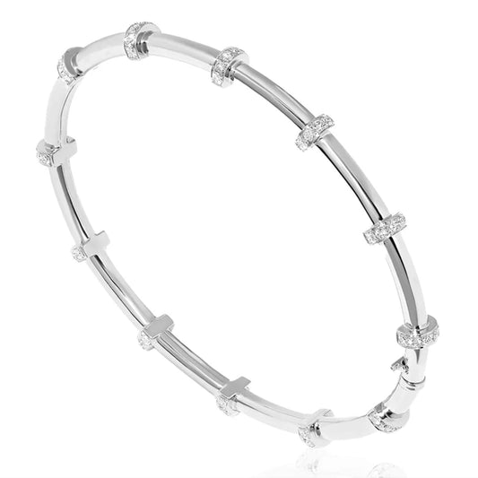 This image displays a sophisticated and elegant silver bangle bracelet. The design features a series of evenly spaced, decorative accents that add a touch of glamour and sophistication.